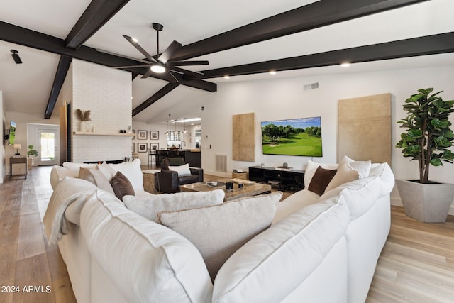 living room with light hardwood / wood-style flooring, vaulted ceiling with beams, and ceiling fan