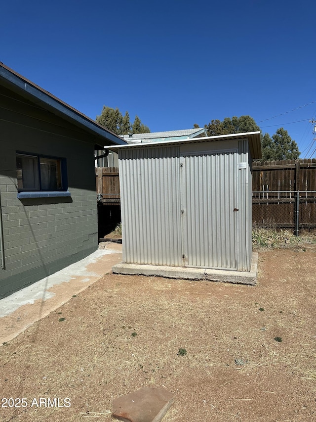 view of shed with fence