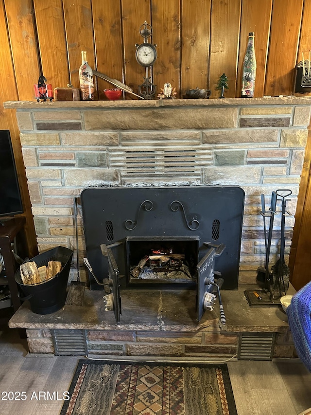 room details with a fireplace and wood finished floors