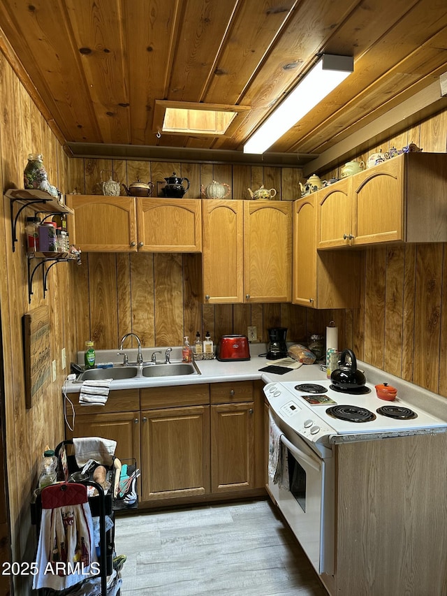 kitchen with white electric range oven, wooden walls, wood ceiling, light countertops, and a sink