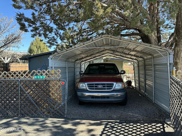 view of parking / parking lot with a carport and fence