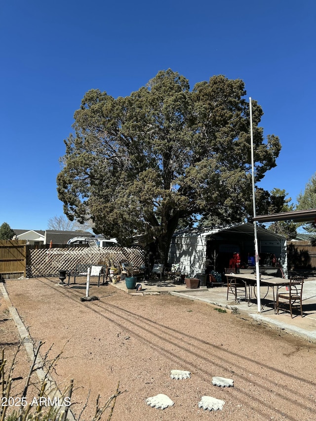 view of yard with fence and a patio