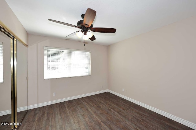 unfurnished bedroom with dark wood-type flooring, ceiling fan, and a closet