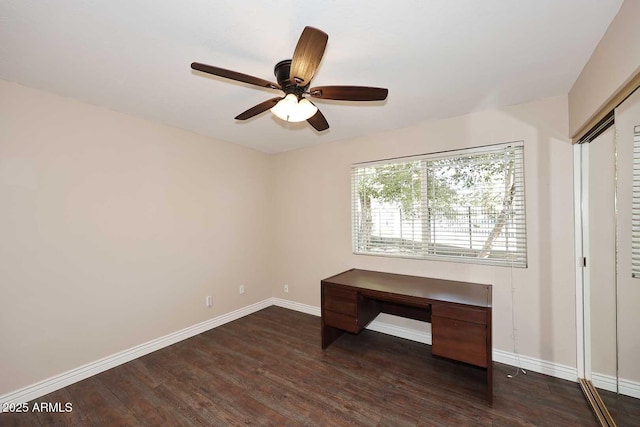 unfurnished office with dark wood-type flooring and ceiling fan