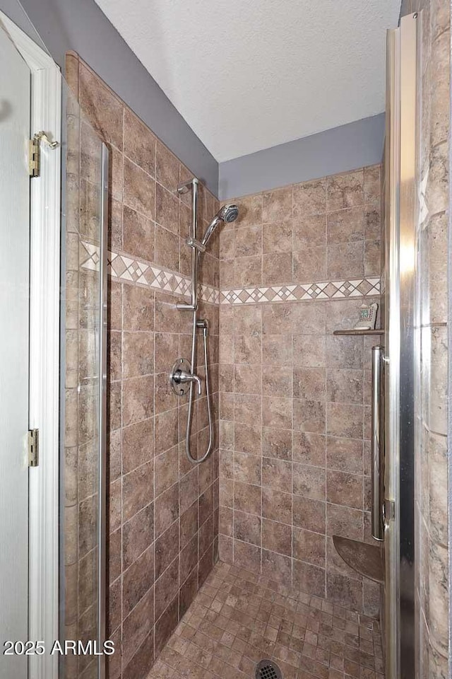 bathroom with a shower with door