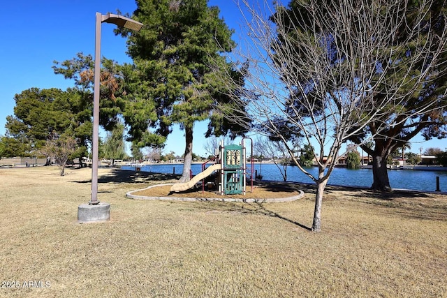 view of playground with a water view and a yard