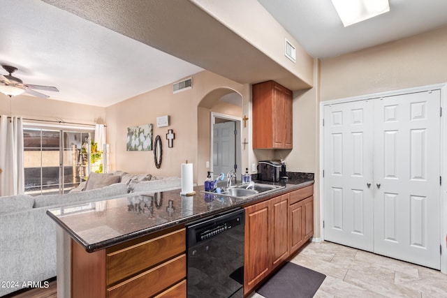 kitchen featuring kitchen peninsula, black dishwasher, ceiling fan, dark stone counters, and sink