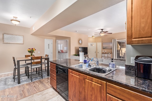 kitchen featuring light hardwood / wood-style floors, black dishwasher, sink, and ceiling fan