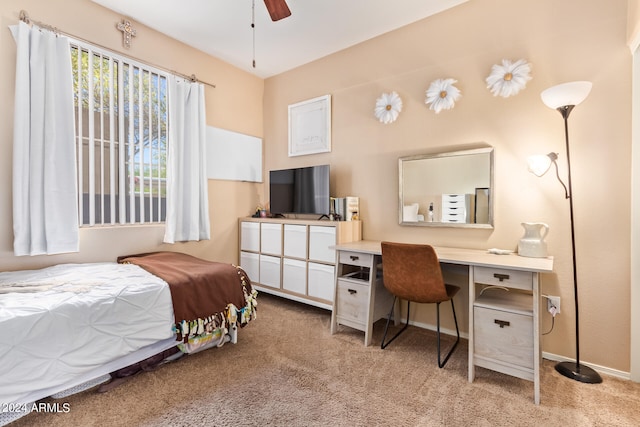 carpeted bedroom featuring built in desk and ceiling fan