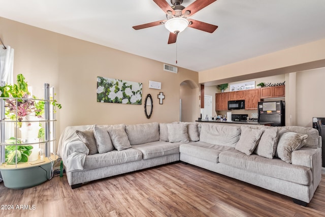 living room with ceiling fan and light hardwood / wood-style flooring