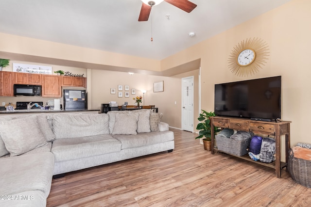 living room with ceiling fan and light wood-type flooring