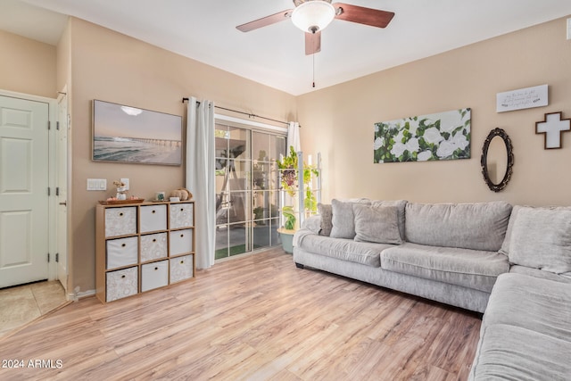 living room with light hardwood / wood-style flooring and ceiling fan