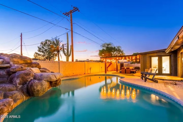view of swimming pool featuring a fenced in pool, a patio, and a fenced backyard