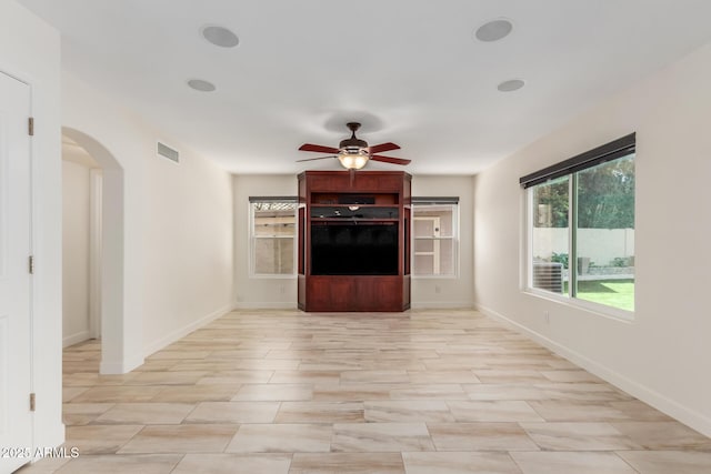 unfurnished living room featuring ceiling fan