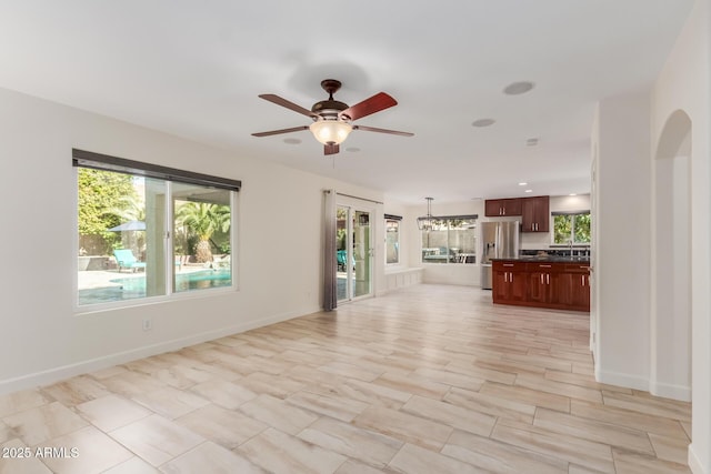 unfurnished living room featuring ceiling fan