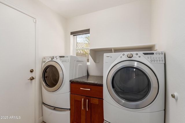 washroom featuring independent washer and dryer and cabinets