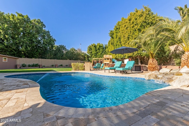 view of swimming pool with pool water feature, a playground, and a patio