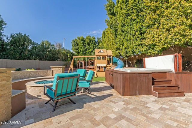 view of patio / terrace featuring a hot tub and a playground