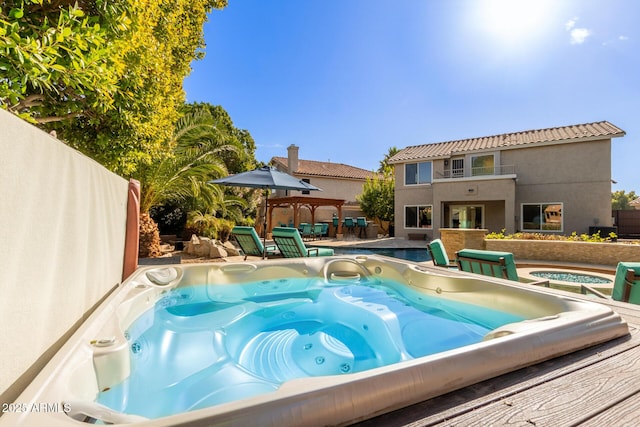 view of swimming pool featuring an outdoor hot tub