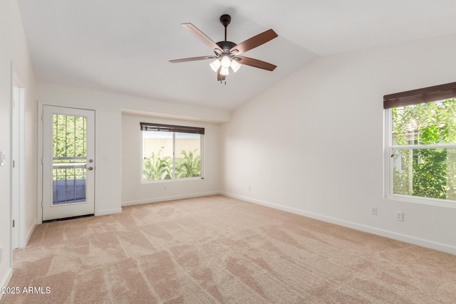 spare room with ceiling fan, lofted ceiling, light carpet, and a wealth of natural light