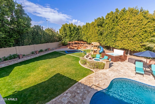 view of pool featuring a lawn, a hot tub, a playground, and a patio area