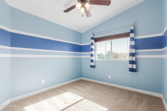 carpeted empty room featuring lofted ceiling and ceiling fan