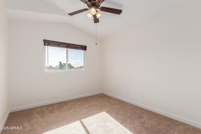 carpeted empty room featuring ceiling fan and lofted ceiling