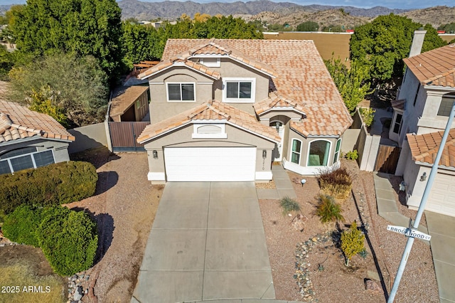 view of front of house with a garage and a mountain view