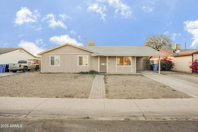 ranch-style house featuring a carport