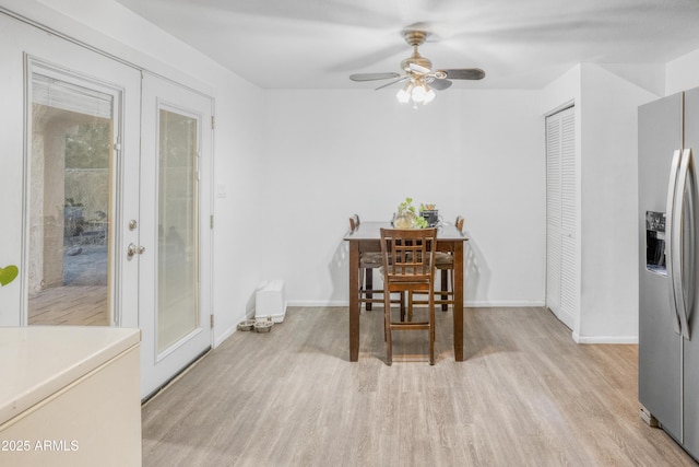 dining space featuring light hardwood / wood-style floors, french doors, and ceiling fan