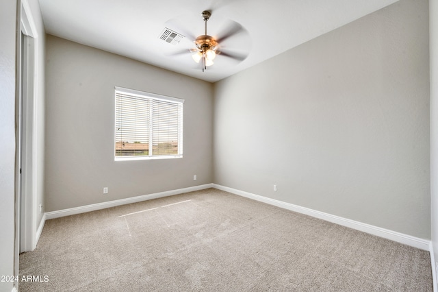 carpeted spare room with ceiling fan