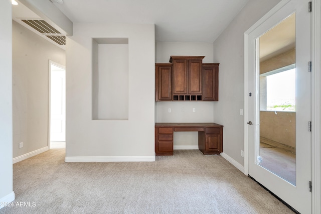 kitchen featuring light carpet