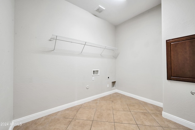 laundry room featuring hookup for a washing machine, gas dryer hookup, hookup for an electric dryer, and light tile patterned flooring