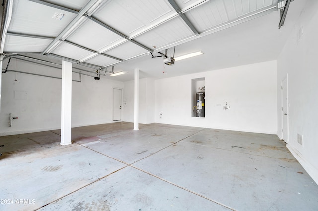 garage featuring gas water heater and a garage door opener