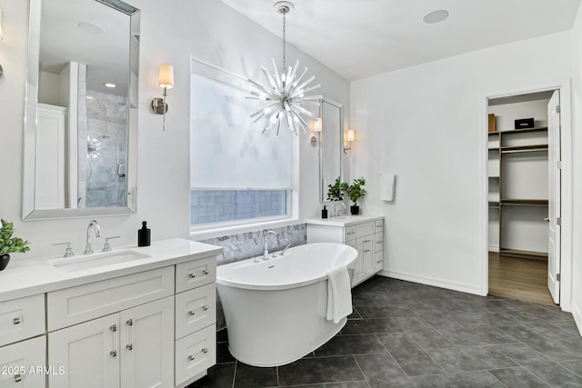 3038 E Longhorn Dr, Gilbert, AZ 85297 - bathroom with two vanities, a freestanding tub, a stall shower, a chandelier, and a spacious closet