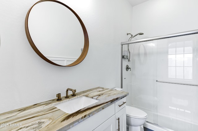 3038 E Longhorn Dr, Gilbert, AZ 85297 - bathroom featuring a shower with shower door, vanity, and toilet