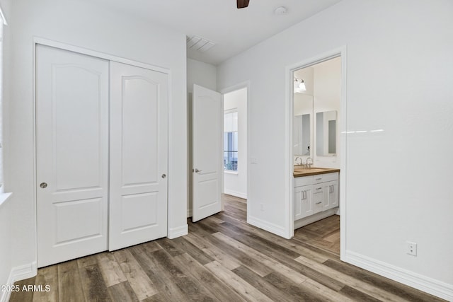 3038 E Longhorn Dr, Gilbert, AZ 85297 - unfurnished bedroom featuring a closet, wood finished floors, baseboards, a sink, and ensuite bath