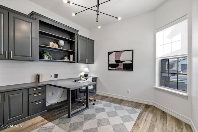 3038 E Longhorn Dr, Gilbert, AZ 85297 - office space featuring light wood finished floors, a chandelier, baseboards, and built in desk