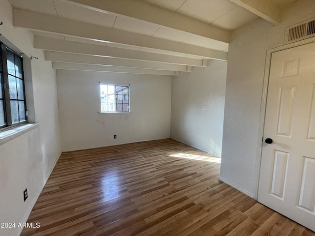 interior space featuring beam ceiling and hardwood / wood-style flooring