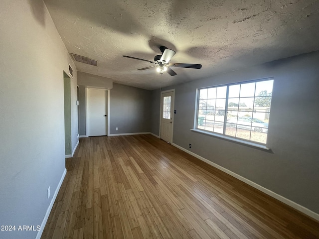 interior space with ceiling fan, light hardwood / wood-style flooring, and a textured ceiling