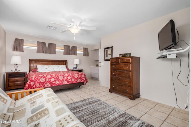 bedroom featuring light tile patterned floors, visible vents, and ceiling fan