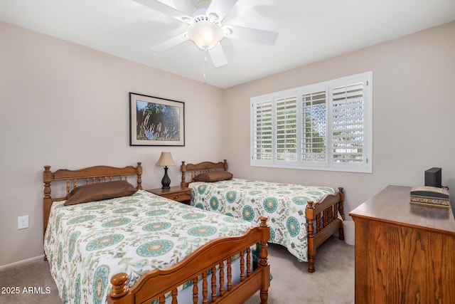 carpeted bedroom with baseboards and a ceiling fan