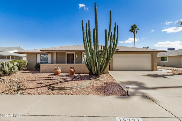 ranch-style house featuring stucco siding, driveway, and an attached garage