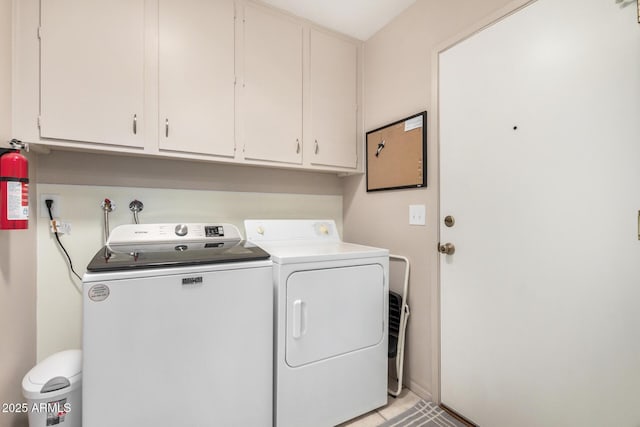 washroom with separate washer and dryer and cabinet space