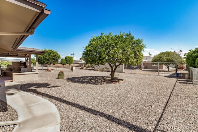 view of yard featuring an outdoor kitchen, a patio, and fence