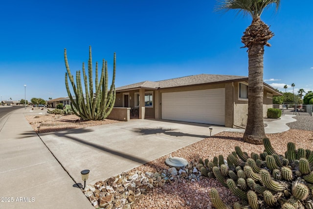 view of front of property featuring a garage, driveway, and stucco siding