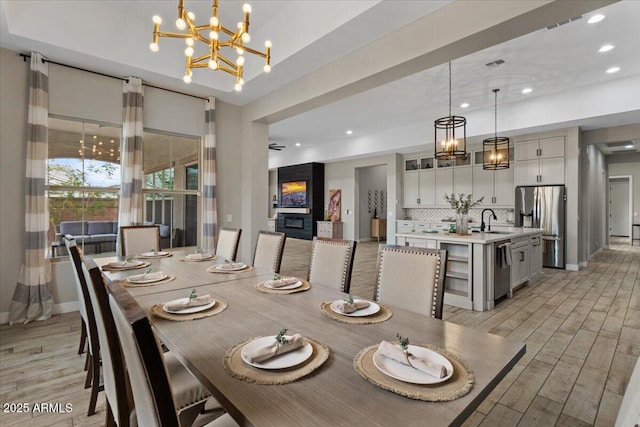 dining room featuring sink and an inviting chandelier