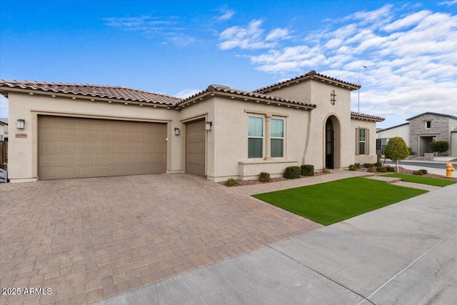 mediterranean / spanish-style house with a garage