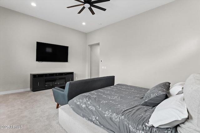 carpeted bedroom featuring a fireplace and ceiling fan