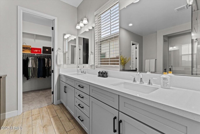 bathroom featuring vanity and a shower with shower door